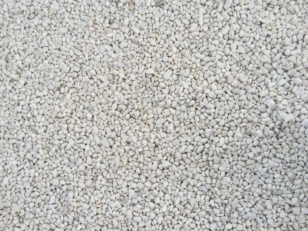 a close up of a white carpet with small rocks