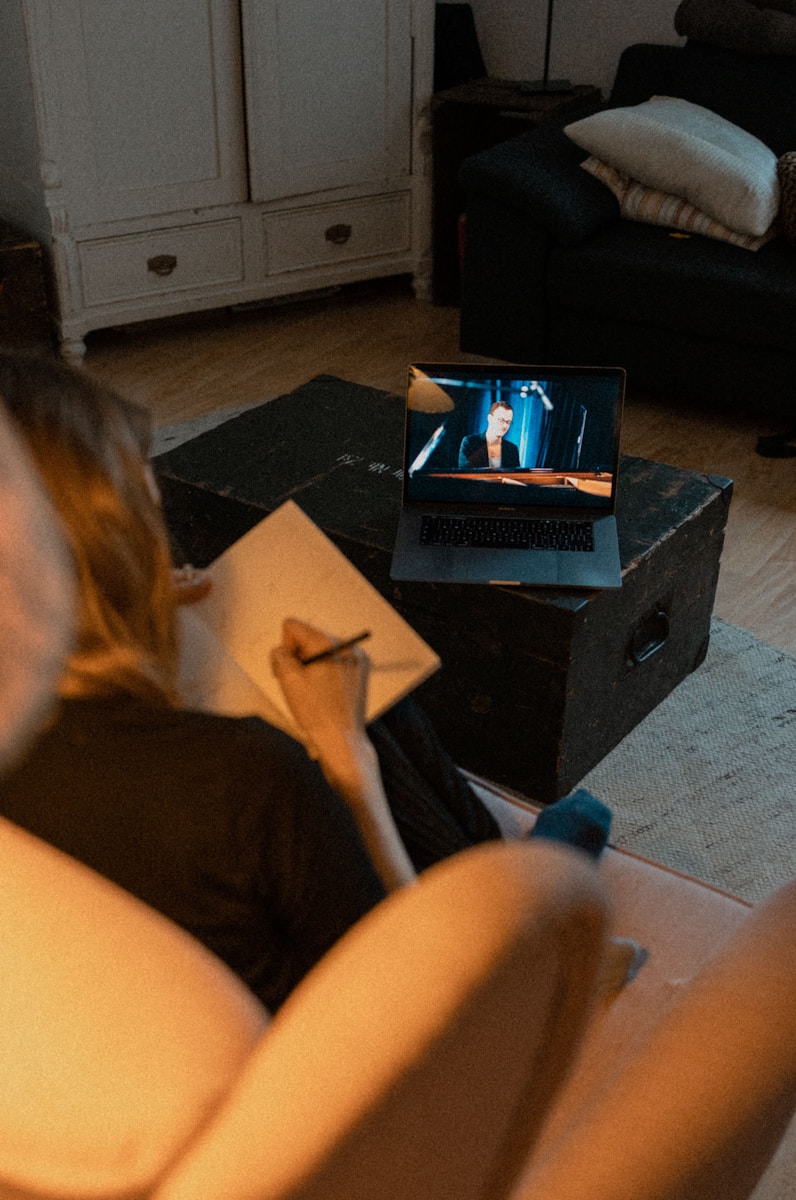 woman in black shirt sitting on black sofa